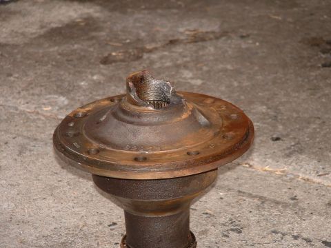 1990 Ford Bronco - A damaged differential housing sits on a concrete surface.