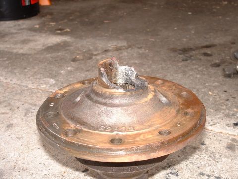 1990 Ford Bronco - A close-up view of a damaged differential housing, showing the part number 62839 stamped into the metal.