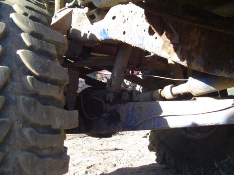 1993 Ford Bronco - Undercarriage view of a vehicle, focusing on its suspension and large tires.