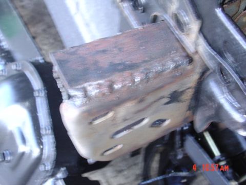 1991 Ford F-150 - This image shows a close-up view of a metal bracket that has been welded onto a vehicle's frame.