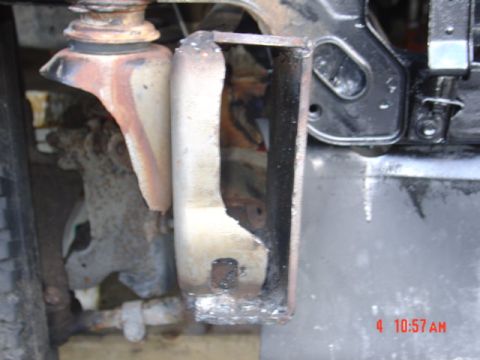 1991 Ford F-150 - A close-up view of a heavily rusted suspension component, showing signs of modification and wear.