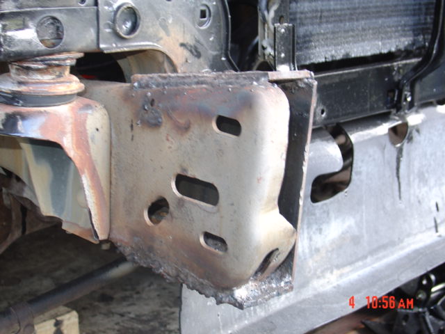 Close-up of a truck's frame with welding marks and some rust