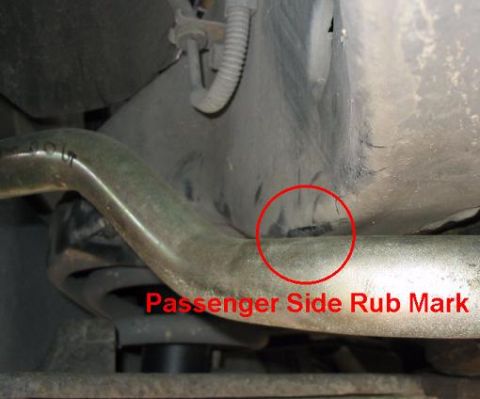 1999 Ford Crown Victoria - Close-up view of a vehicle's undercarriage, showing a suspension component with a marked rub area.