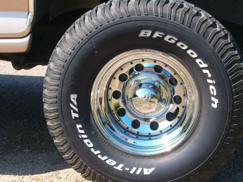 1996 Ford Bronco - This photo shows a close-up of a BFGoodrich All-Terrain tire and a shiny chrome wheel on a vehicle.