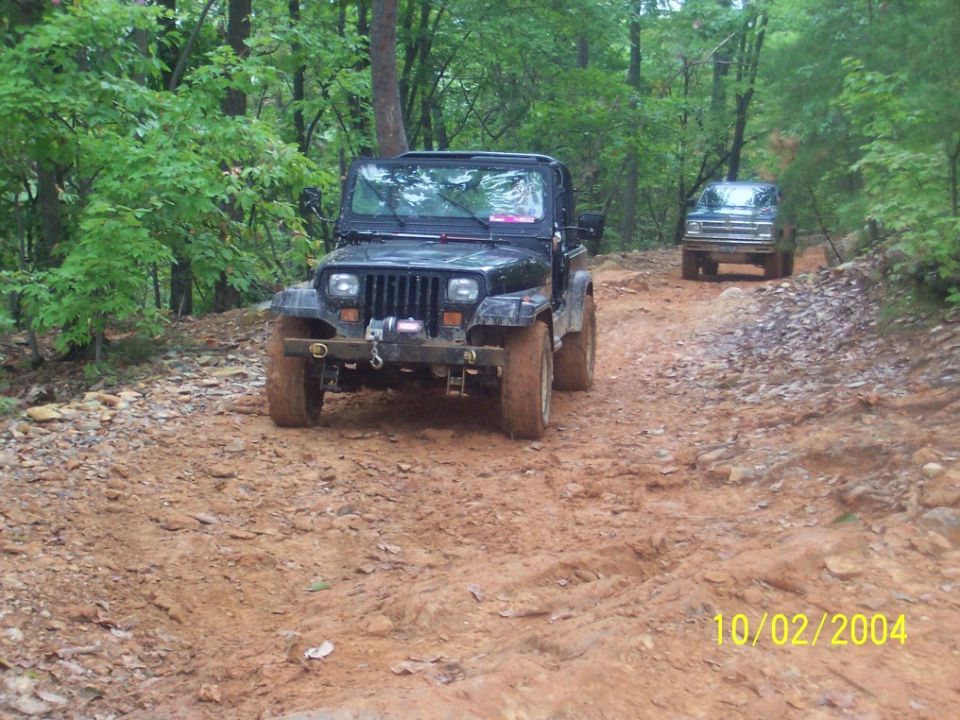 1994 Jeep YJ and another SUV on a muddy trail