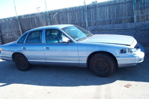 1991 Ford LTD Crown Victoria - This sedan has a distinctive body style from the mid-1990s, with a missing grille and headlights.