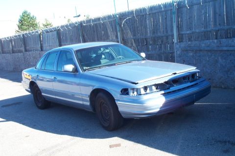 1991 Ford LTD Crown Victoria - This 1991 Ford Crown Victoria LTD sedan shows damage to its front end and has its hood open.