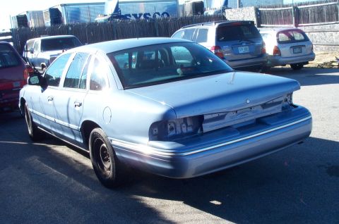 1991 Ford LTD Crown Victoria - Light blue 1991 Ford Crown Victoria LTD seen from the rear, missing its bumper and taillights.