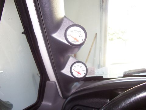 1994 Ford Bronco - This photo shows aftermarket water and oil pressure gauges installed inside a vehicle's cabin.