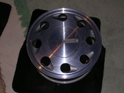 2003 Chevrolet Monte Carlo - A single silver car wheel is shown, resting on a dark mat.