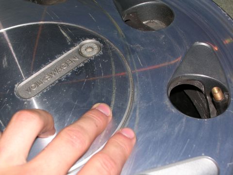 2003 Chevrolet Monte Carlo - A close-up view of a Volkswagen hubcap, showing the embossed brand name and part of the wheel assembly.