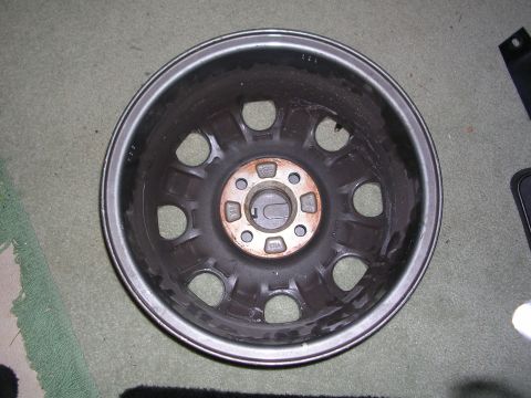2003 Chevrolet Monte Carlo - Close-up of a single car wheel rim, showing its internal structure and lug nut pattern.