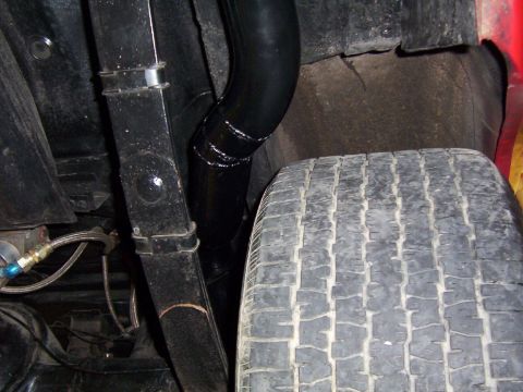 1963 Ford Fairlane - Undercarriage detail with tire and exhaust pipe visible.