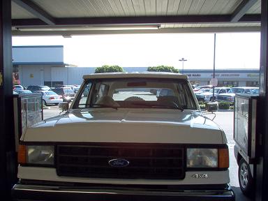 1988 Ford Bronco - Front view of a white 1988 Ford Bronco parked under a structure.