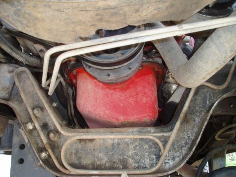 1990 Ford Bronco - Underside view of a red engine oil pan with associated engine components.