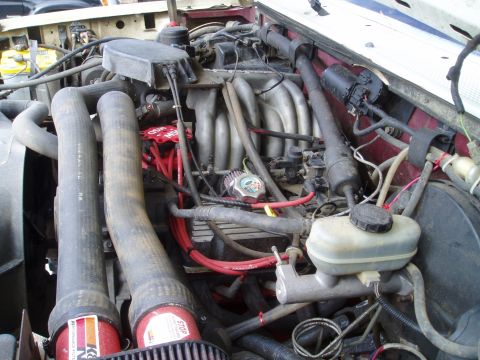 1990 Ford Bronco - Close-up view of a vehicle's engine bay, showing various components and aftermarket parts.