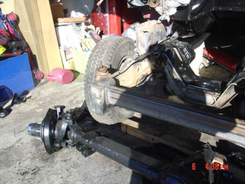 1991 Ford F-150 - Close-up view of the front axle and suspension assembly, likely undergoing repair or modification.