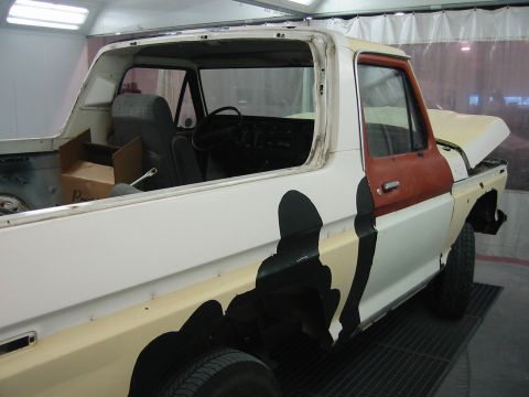 1992 Ford Bronco - Side view of a Ford F-Series truck cab and bed in a repair shop.