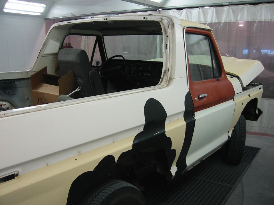 Ford F-Series truck cab and bed undergoing repair, showing interior and side panel