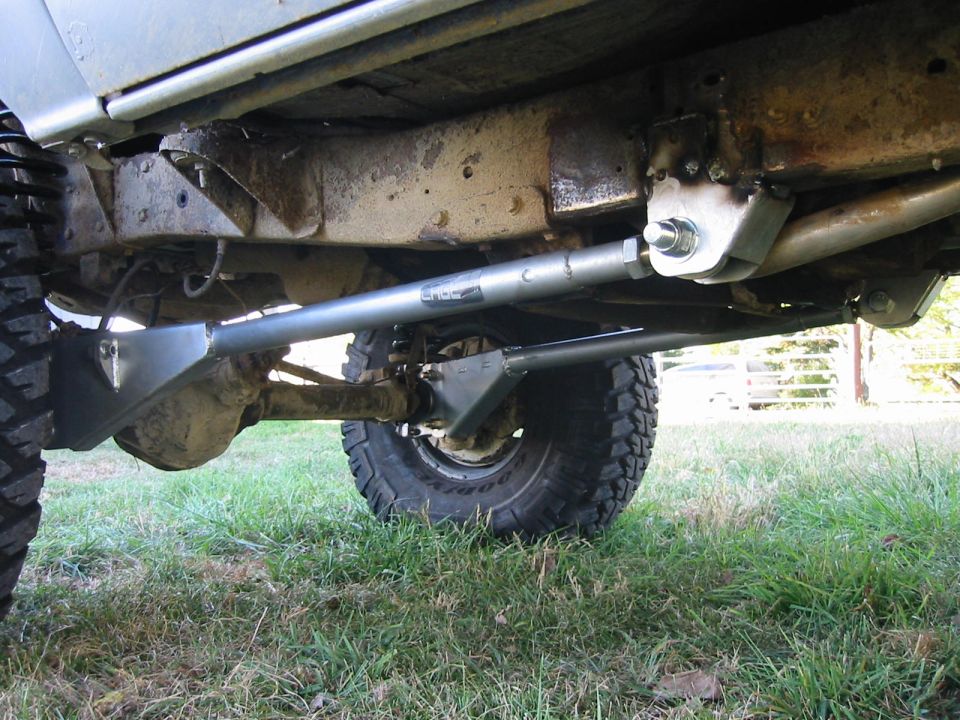 Underbody view of a 4x4 vehicle showing modified suspension components and a rear axle
