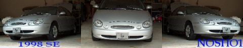 1998 Ford Taurus - Three silver Ford Taurus cars are parked in a garage, with two of them showing their engines.