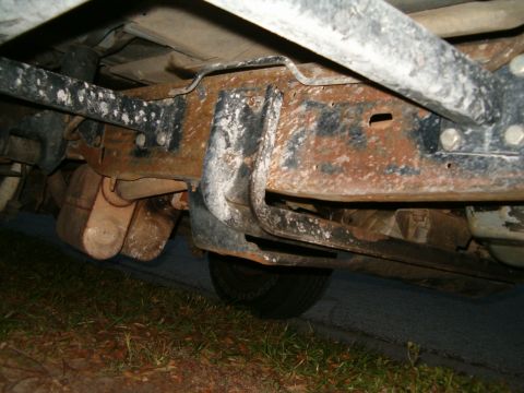 1991 Ford Bronco - Undercarriage of a vehicle, showing significant rust on the frame and suspension parts.