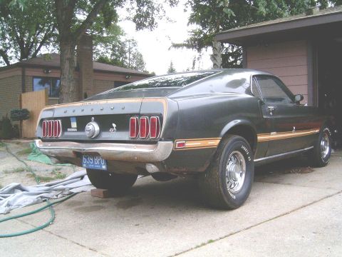 1969 Ford Mustang - Rear view of a 1969 Ford Mustang parked in a driveway.