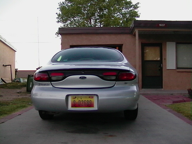 Silver 1999 Ford Taurus rear view, license plate 9-D2689, parked in driveway