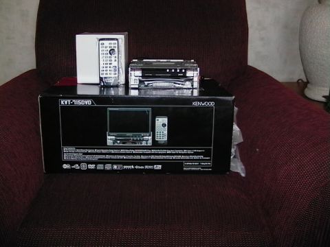 1999 Ford Taurus - A Kenwood car stereo system, including the main unit and remote, is displayed on its packaging box.