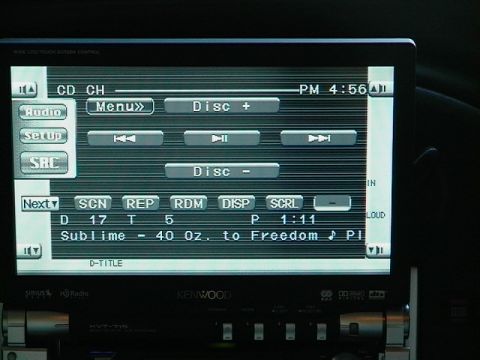 1999 Ford Taurus - Close-up of a Kenwood car stereo's digital display showing track information and menu options.