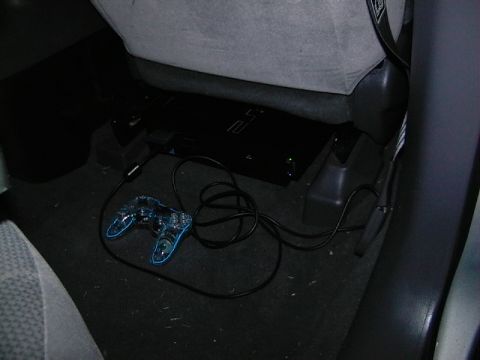 1999 Ford Taurus - A PlayStation 2 console and controller are visible on the floor of a vehicle's interior.