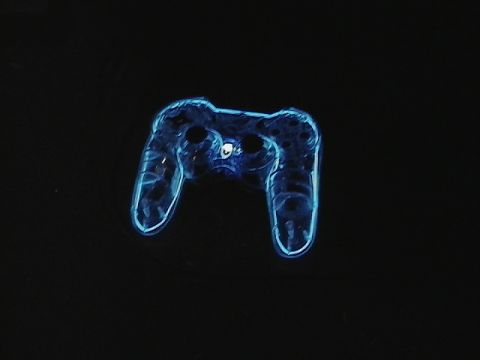 1999 Ford Taurus - A transparent blue game controller is illuminated against a black background, with 'SUPERMOTORS' text visible at the bottom right.