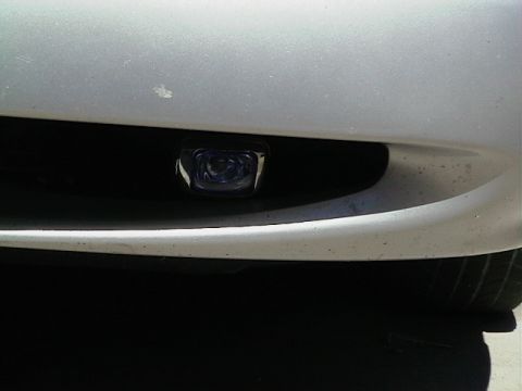 1999 Ford Taurus - A single fog light is mounted in the front bumper of a vehicle.