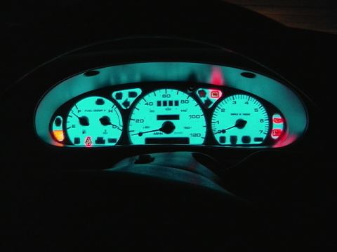1999 Ford Taurus - Interior view of illuminated dashboard gauges, showing speedometer, tachometer, and fuel level.