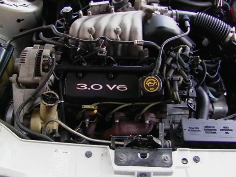 1999 Ford Taurus - The engine bay of a 1999 Ford Taurus shows its 3.0 V6 engine and associated components.