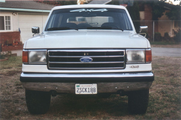 White 1990 Ford Bronco front view with 4x4 windshield sticker and California license plate 2SCK188