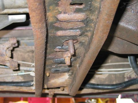 1995 Ford Bronco - Remove the 2 center bolts on the cross member using an 11/16" socket.