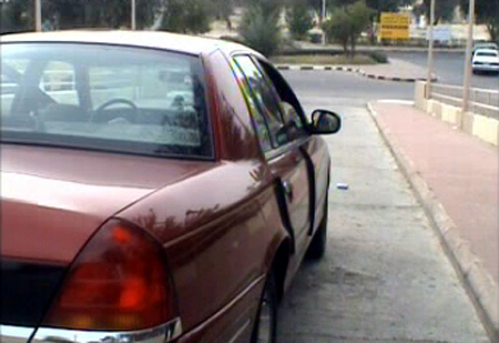 2000 Ford Crown Victoria - Rear quarter view of a red 2000 Ford Crown Victoria parked curbside.