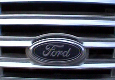 2000 Ford Crown Victoria - Close-up of a Ford emblem on a vehicle's front grille.