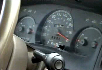 2000 Ford Crown Victoria - The vehicle's dashboard shows the speedometer, odometer, and gear selector.
