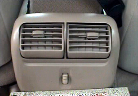 2000 Ford Crown Victoria - Rear air vents and a control switch are visible in the interior of a vehicle.