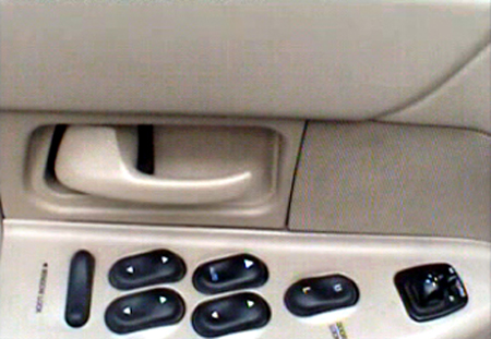 2000 Ford Crown Victoria - Interior view of a 2000 Ford Crown Victoria's driver's side door panel, showing window controls.