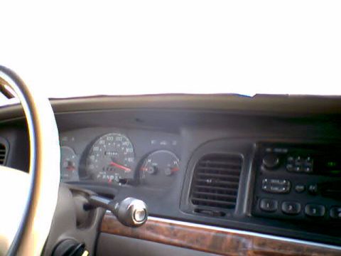 2000 Ford Crown Victoria - The dashboard of a 2000 Ford Crown Victoria, showing the instrument cluster and center console.