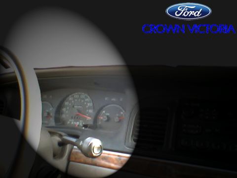 2000 Ford Crown Victoria - The instrument cluster and steering wheel are visible in the interior of a 2000 Ford Crown Victoria.