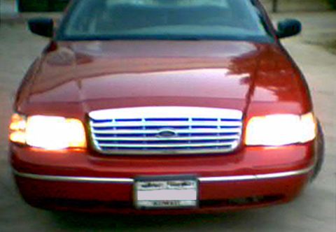 2000 Ford Crown Victoria - Front view of a red 2000 Ford Crown Victoria showing its grille and headlights.