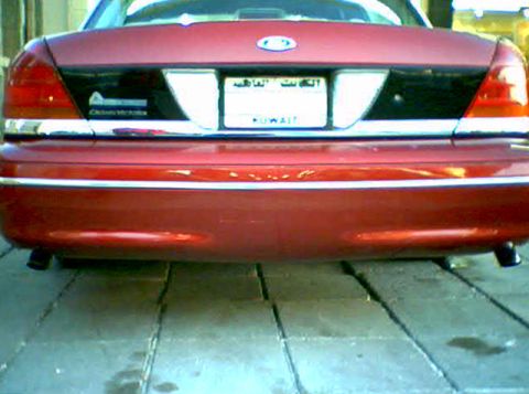 2000 Ford Crown Victoria - Rear view of a red 2000 Ford Crown Victoria, a Kuwaiti license plate.