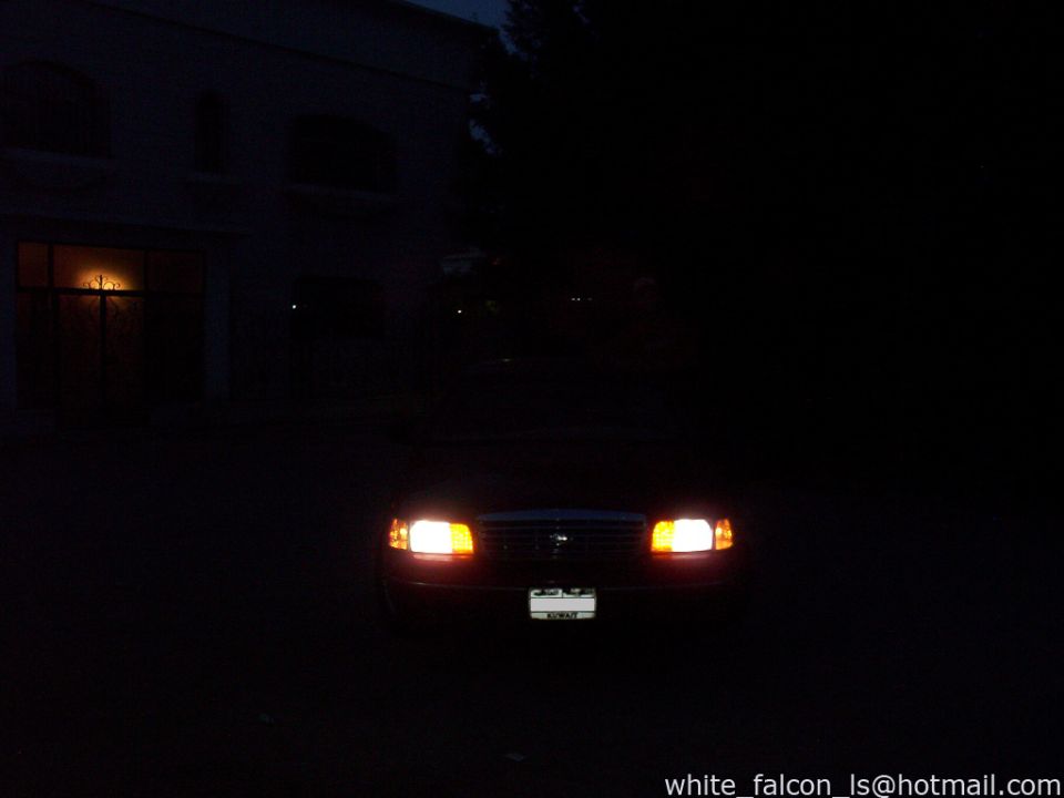 2000 Ford Crown Victoria front view at night with headlights on