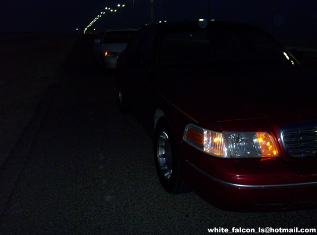 2000 Ford Crown Victoria front corner parked at night, another car visible behind it