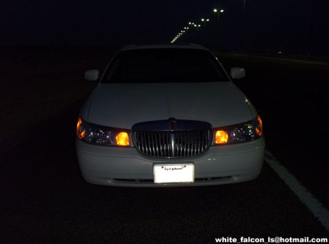 2000 Ford Crown Victoria - This white sedan's grille and headlight design suggest a 2003 model year, not a 2000 Ford Crown Victoria.