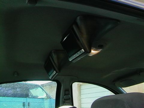 1999 Ford Taurus - Aftermarket video screens installed in the vehicle's interior.